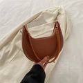 Classic brown leather crescent shoulder bag with golden zipper and luxury texture - Brown