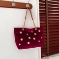 Elegant burgundy velvet tote bag with gold floral studs and metal chain straps - Red