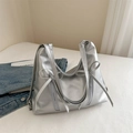 Zilveren schoudertas met strikdetails en metallic afwerking in een modieuze en trendy look - Zilver