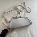 Silver metallic trapezoid shoulder bag with gold logo text on a stylish background - Silver