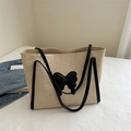 Large beige woven straw tote bag featuring black leather straps and butterfly patch - Black