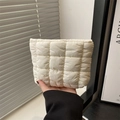 Minimalist white checkered quilted clutch bag made of padded nylon fabric held in hand - White