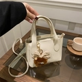 Bolso tipo cubo de cuero lichi blanco crema con colgante de monstruo de peluche marrón - Con Colgante / Blanco