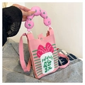 Detailed close-up of pink knitted mini crossbody bag with red bow and unique round handle - Pink Bowknot Lucky Style (Style 6)