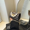 Chic leopard print crossbody bag featuring a large pearl handle and gold chain strap - Leopard Style