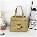 Close-up of khaki canvas tote with three embroidered bears and a convenient front pocket - Embroidery Style - Khaki