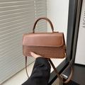 Brown woven crossbody bag featuring smooth leather flap and vintage textured finish - Brown