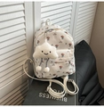 Close-up of white floral mini backpack with a plush cloud charm and adjustable straps - With Pendant / White