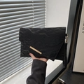 Minimalist black envelope clutch with crinkled texture and golden metal bar detail - Black