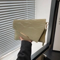 Grass green pleated envelope clutch with asymmetric flap and golden metal hardware detail - Green