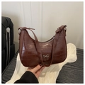 Detail of dark brown croc-effect hobo bag with silver bow buckle and zip closure - Coffee