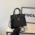Elegant black glossy leather handbag with gold hardware and adjustable strap - Black