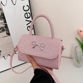 Elegant pink sequin crossbody bag with silver bow accent and versatile shoulder strap - Pink