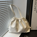 Creamy white drawstring bucket bag with soft pleated texture and silver bow detail - White