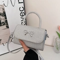 Sparkly silver crossbody bag with a metallic bow and elegant sequin finish for women - Silver