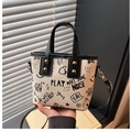 Graffiti print bucket bag in off-white faux leather with black cartoon pattern and top handle - Black