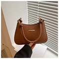 Detail of brown woven textured hobo bag with gold metal trim and knotted strap - Tan