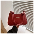 Detail of dark red woven texture leather bag with gold hardware and knotted handle - Red