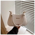 Close-up of white woven leather handbag texture with minimalist gold metal hardware detail - White