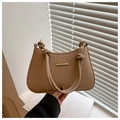 Close-up of tan woven texture underarm bag with knot strap and gold metal bar accent - Khaki