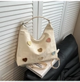 Cream tote bag with colorful heart patches and crinkled leather texture for women - White