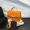 Quilted orange chain crossbody bag with gold buckle and elegant top handle for women - Brown