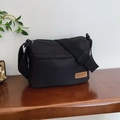 Fashionable black nylon crossbody bag with dual zippers and adjustable wide strap - Black