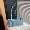 Light blue faux leather baguette shoulder bag featuring a sweet lace ribbon bow detail - With Pendant / Blue
