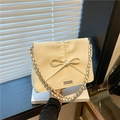 Chic cream bow tote bag with metallic chain strap and silver logo plate detail - White