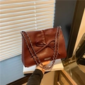 Deep burgundy bow tote bag with silver chain strap and vintage faux leather finish - Red