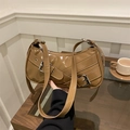 Brown glossy baguette shoulder bag with decorative metal buckle straps in a city style - Khaki