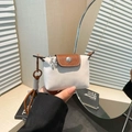 Mini nylon dumpling pouch in white and brown contrast with floral charm and long strap - White