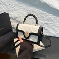 Elegant black and white small crossbody bag with a spiral twisted handle and gold flower lock - Black and White