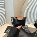 Mini navy nylon dumpling bag with brown pebbled leather flap and silver floral charm - Black