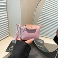 Pink nylon mini storage pouch with leather flap, metal buckle, and flower charm - Pink
