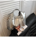 Detail of silver bow handbag with delicate white lace trim and metallic leather finish - Silver