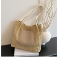 Detail of straw tote bag with leather patch and thick braided rope handles for summer style - Khaki