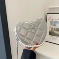 Silver heart-shaped quilted shoulder bag with pearl handle and metal bow detail - Silver