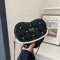 Heart-shaped black quilted crossbody bag with pearl handle and silver bow detail - Black