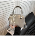 Silver shell crossbody bag with pearl bow and lace charm in metallic finish - With Pendant / Silver