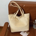 Minimalist cream canvas tote bag with large capacity and stylish side pocket details - Khaki