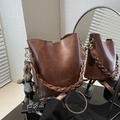 Brown leather bucket bag with woven handle and cute rabbit charm in a mirror reflection - With Pendant / Brown