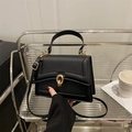 Minimalist black structured crossbody bag with gold ring buckle and matte finish texture - Black