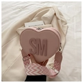 Pink heart-shaped crossbody bag with decorative SM logo and wide patterned strap - Pink
