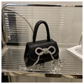 Mini borsa nera a mano con fiocco di strass argento e tracolla a catena in metallo - Nero