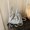 Light blue dumpling bag with golden butterfly charm and elegant pearl chain detail - Blue