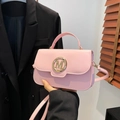 Pink faux leather crossbody bag with golden M metal buckle and top handle detail - Pink