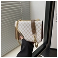 Close-up of vintage shoulder bag with classic monogram print and gold chain strap detail - White
