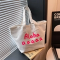White canvas tote bag featuring vibrant pink artistic print for casual summer daily use - White