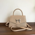 Beige crossbody bag with silver bow accent and adjustable shoulder strap for women - Khaki